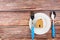 Wooden house in white dish and fork, spoon on woodden table background with copy space.Home Repair concept, Repair maintenance