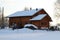 Wooden house in winter, full of snow
