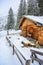 Wooden house in winter mountain landscape. Cottage / Hut in snowy mountains. Travel destination for recreation