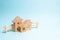 Wooden houses on a blue background. Wooden Toys. The concept of real estate and ownership, the purchase and sale of property. Farm