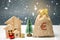 Wooden houses and Christmas tree and a bag of money. Christmas Sale of Real Estate. New Year discounts for buying house. Purchase
