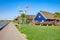 Wooden houses in Nida, Lithuania with dunes on background