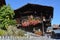 Wooden houses wreathed with flowers in a mountain village in the Alps