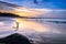 Wooden Human Manikin posing on a beach with a beautiful sunset from a view point on a beach in Mossel Bay