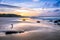 Wooden Human Manikin posing on a beach with a beautiful sunset from a view point on a beach in Mossel Bay