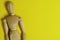 Wooden Human mannequin on a bright yellow background