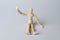 Wooden human model on grey. Mini mannequin