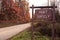 A wooden `HUNT SAFELY` sign on the side of the road