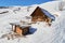 Wooden hut and barracks on a slope at Les Sybelles ski domain, France, on a sunny day with blue sky, early Spring