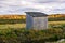 Wooden hut in the field. Holidays in the countryside. A small wooden house