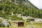 Wooden huts at Beyal Camp grassland