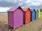 Wooden huts of various colors in the sand of Oropesa del Mar beach on a cloudy day, in CastellÃ³n, in Spain. Europe.