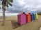 Wooden huts of various colors in the sand of Oropesa del Mar beach on a cloudy day, in CastellÃ³n, in Spain. Europe.