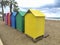 Wooden huts of various colors in the sand of Oropesa del Mar beach on a cloudy day, in CastellÃ³n, in Spain. Europe.