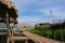 Wooden huts with walkway and blue sky.