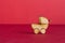 Wooden icon of baby carriage on red background