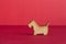 Wooden icon of dog on red background