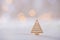 Wooden icon of triangular Christmas tree with garland lights on