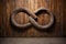 a wooden infinity symbol against an old rustic wall