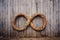 a wooden infinity symbol against an old rustic wall