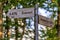 Wooden information arrows of tourist navigation pointing directions and distance to Everest and Aconcagua mountain peaks in