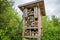 Wooden insect house in the garden. Bug hotel in natural environment. Insect hotel in Switzerland