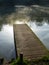 Wooden jetty on the banks of the Thames with mist on the water