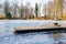 Wooden jetty on a frozen lake in a garden