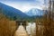 Wooden jetty with gate in the tegernsee lake, snow-covered mount