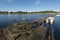 Wooden Jetty in Stangeskroken bay in Sweden. The coastal camping side of Landon village is at background. Jamtland