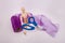 Wooden jointed manikin doll holding scissors purple tulle fabric roll in background