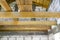 Wooden joists prepared for laying the attic floor of a newly built white brick house.