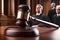 Wooden judge gavel on brown table in courtroom with blurred judge