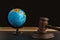 Wooden Judge gavel and globe. International Environment law. Law and justice court concept