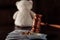 Wooden judge gavel, money banknotes, rings and teddy bear close-up. Divorce and alimony concept