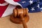 Wooden judge`s gavel on the background of the American flag. Concept: claim and compensation for damages, court session, announcem