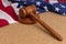 Wooden judge`s gavel on the background of the American flag. Concept: claim and compensation for damages, court session, announcem