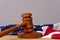 Wooden judge`s gavel on the background of the American flag. Concept: claim and compensation for damages, court session, announcem