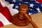 Wooden judge`s gavel on the background of the American flag. Concept: claim and compensation for damages, court session, announcem