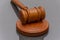 Wooden judge`s gavel on a dark background. Concept: claim and compensation for damages, court session, announcement of the verdict