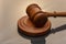 Wooden judge`s gavel on a dark background. Concept: claim and compensation for damages, court session, announcement of the verdict