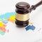 Wooden judge\'s gavel over colorful world map - close up shot