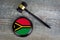 Wooden judgement or auction mallet with of Vanuatu flag. Conceptual image