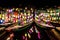 Wooden junk boats with colorful lantern lamps on the river in the ancient town of Hoi An, Vietnam