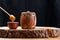 Wooden keg with honey and honey spoon on a wooden saw on a dark background. Barrel