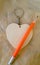 Wooden keychain like heart and pencil.