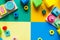 Wooden kids toys on colourful paper. Educational toys blocks. Toys for kindergarten, preschool or daycare. Copy space for text.
