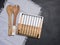 Wooden kitchen spatulas and a metal stand for hot dishes, top view