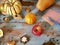 On the wooden kitchen table pumpkins, nuts, apples, paper and pencil to write down the recipe