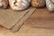 Wooden kitchen top with bread and rolls on a jute bag